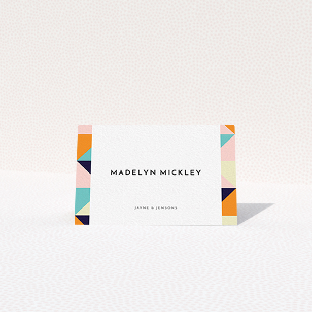 A table place card called "Sloane Squares". It is an 85 x 55mm card in a landscape orientation. "Sloane Squares" is available as a folded card, with mainly orange colouring.