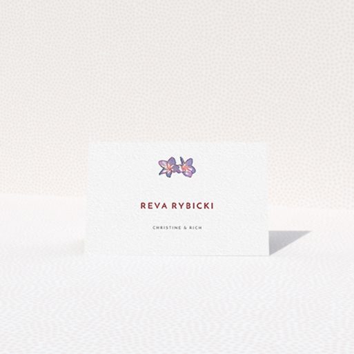 Table Place Card Design - "Two little Orchids" A table place card template titled "Two little Orchids". It is an 85 x 55mm card in a landscape orientation. "Two little Orchids" is available as a folded card, with tones of white and purple.