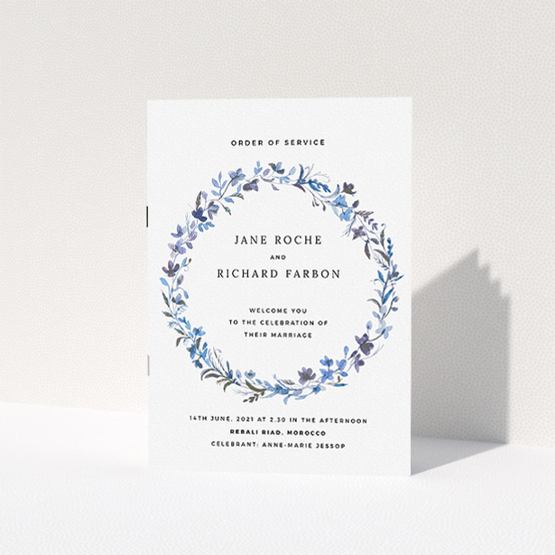 A wedding order of service design titled "Blue Wildflower". It is an A5 booklet in a portrait orientation. "Blue Wildflower" is available as a folded booklet booklet, with tones of light blue, purple and grey.