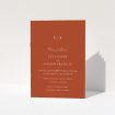 A wedding order of service named "Dark Ochre Monogrammed". It is an A5 booklet in a portrait orientation. "Dark Ochre Monogrammed" is available as a folded booklet booklet, with mainly dark orange colouring.