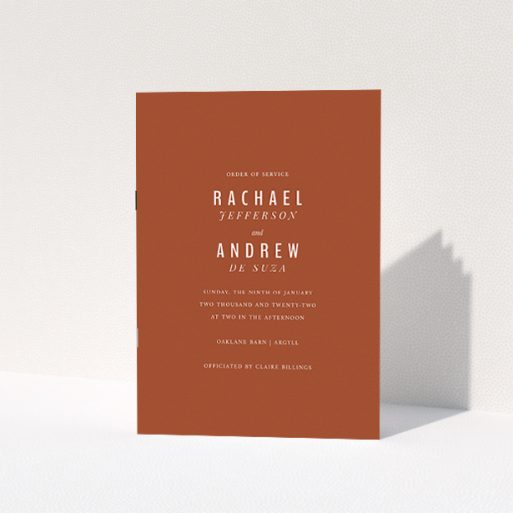 Wedding Order Of Service Design - "Ochre with Typography" A wedding order of service named "Ochre with Typography". It is an A5 booklet in a portrait orientation. "Ochre with Typography" is available as a folded booklet booklet, with mainly dark orange colouring.