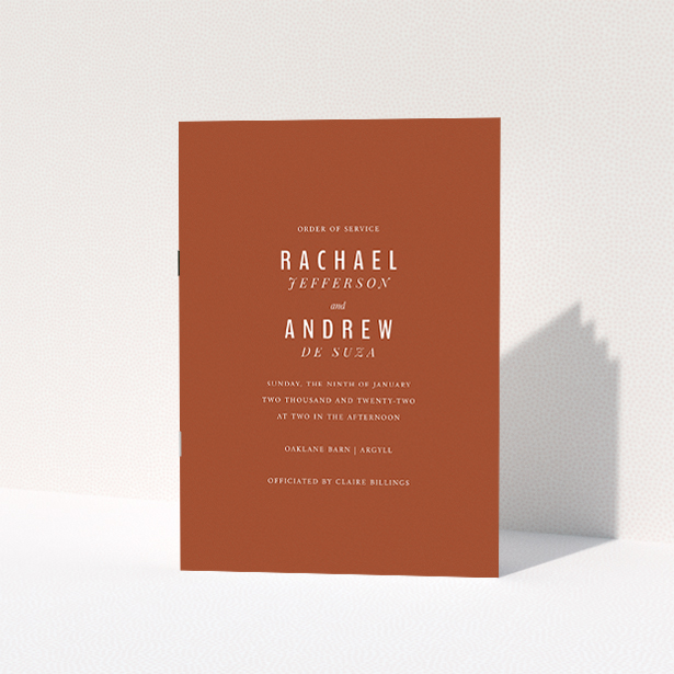 A wedding order of service named "Ochre with Typography". It is an A5 booklet in a portrait orientation. "Ochre with Typography" is available as a folded booklet booklet, with mainly dark orange colouring.