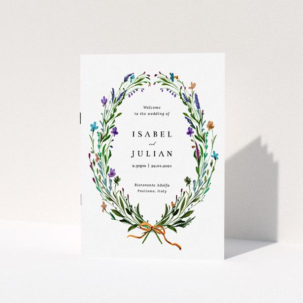 A wedding order of service named "Spring Wildflower Wreath". It is an A5 booklet in a portrait orientation. "Spring Wildflower Wreath" is available as a folded booklet booklet, with tones of green and purple.