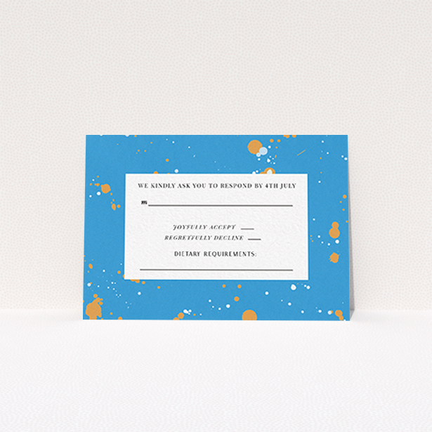 A wedding rsvp card design named "Orange Splatters". It is an A7 card in a landscape orientation. "Orange Splatters" is available as a flat card, with tones of light blue and orange.