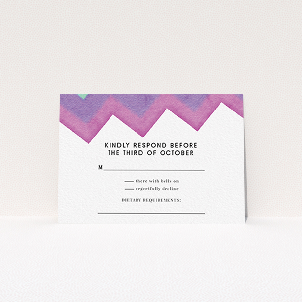A wedding rsvp card design named "Vibrant Peaks". It is an A7 card in a landscape orientation. "Vibrant Peaks" is available as a flat card, with tones of white, dark pink and purple.