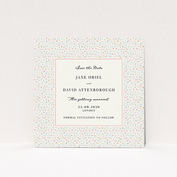 A wedding save the date card named "A hint of confetti". It is a square (148mm x 148mm) card in a square orientation. "A hint of confetti" is available as a flat card, with tones of light cream and green.