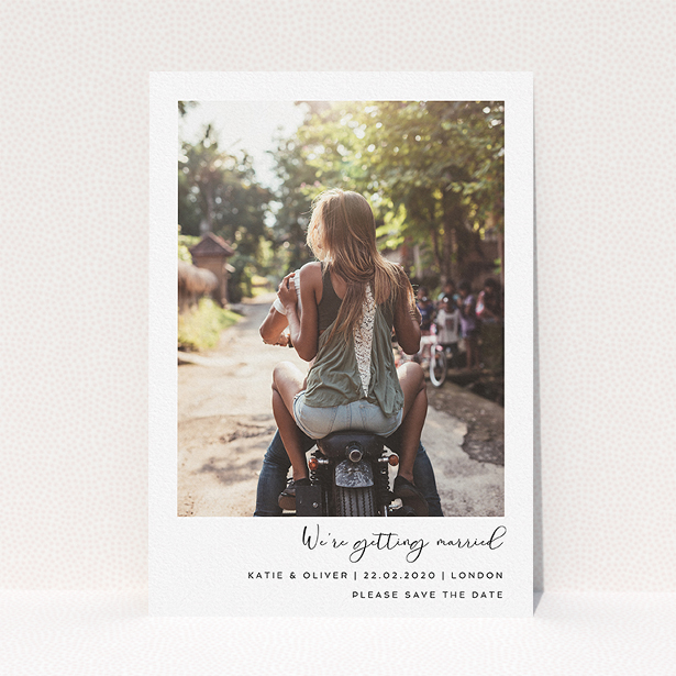 A wedding save the date card template titled "Hoxton Square". It is an A5 card in a portrait orientation. It is a photographic wedding save the date card with room for 1 photo. "Hoxton Square" is available as a flat card, with mainly white colouring.