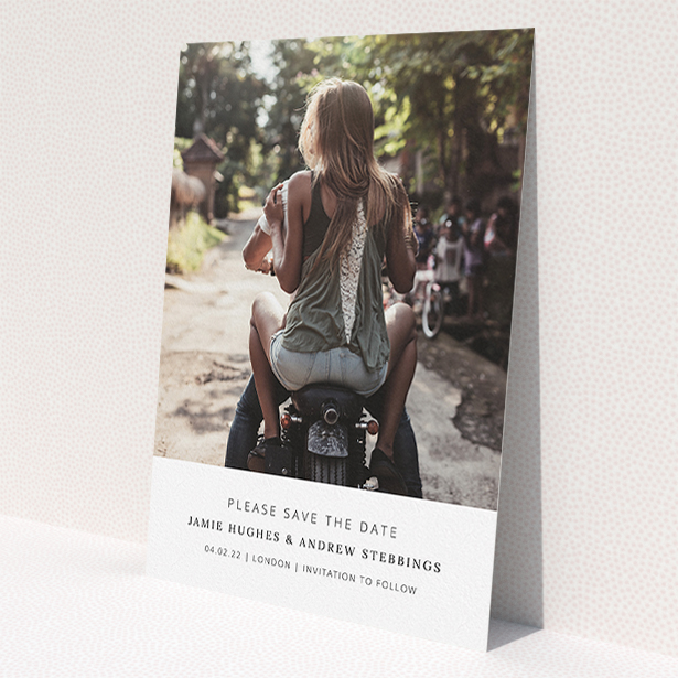 A wedding save the date card named "Maddox Street". It is an A5 card in a portrait orientation. It is a photographic wedding save the date card with room for 1 photo. "Maddox Street" is available as a flat card, with mainly white colouring.