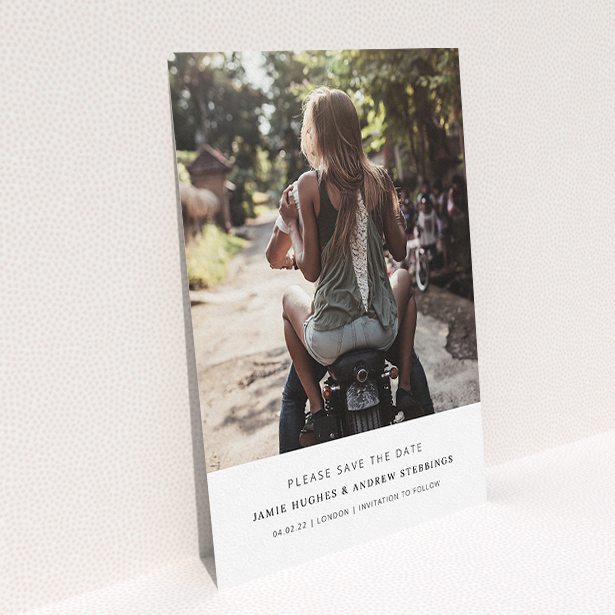 A wedding save the date card named "Maddox Street". It is an A5 card in a portrait orientation. It is a photographic wedding save the date card with room for 1 photo. "Maddox Street" is available as a flat card, with mainly white colouring.