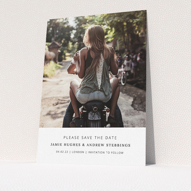 A wedding save the date card named "Maddox Street". It is an A5 card in a portrait orientation. It is a photographic wedding save the date card with room for 1 photo. "Maddox Street" is available as a flat card, with mainly white colouring.