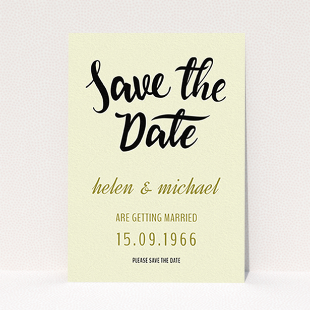 A wedding save the date card called "Simply Black Typography Pen". It is an A6 card in a portrait orientation. "Simply Black Typography Pen" is available as a flat card, with tones of cream, gold and black.