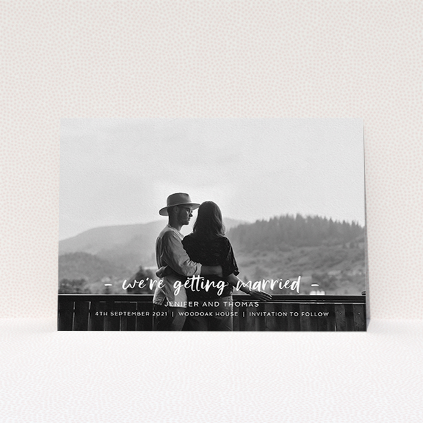 A wedding save the date called "To the Point". It is an A5 save the date in a landscape orientation. It is a photographic wedding save the date with room for 1 photo. "To the Point" is available as a flat save the date, with mainly white colouring.