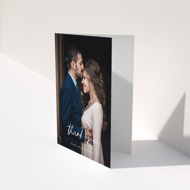 A wedding thank you card design titled "Calligraphy Thanks". It is an A5 card in a portrait orientation. It is a photographic wedding thank you card with room for 1 photo. "Calligraphy Thanks" is available as a folded card, with mainly white colouring.