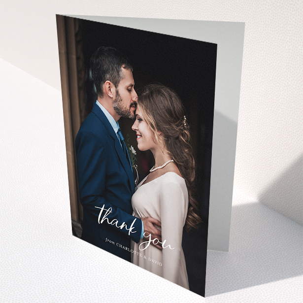 A wedding thank you card design titled "Calligraphy Thanks". It is an A5 card in a portrait orientation. It is a photographic wedding thank you card with room for 1 photo. "Calligraphy Thanks" is available as a folded card, with mainly white colouring.