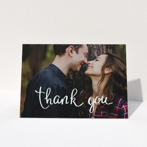 Wedding Thank You Card Design - "Curly thank you" A wedding thank you card design named "Curly thank you". It is an A5 card in a landscape orientation. It is a photographic wedding thank you card with room for 1 photo. "Curly thank you" is available as a folded card, with mainly white colouring.