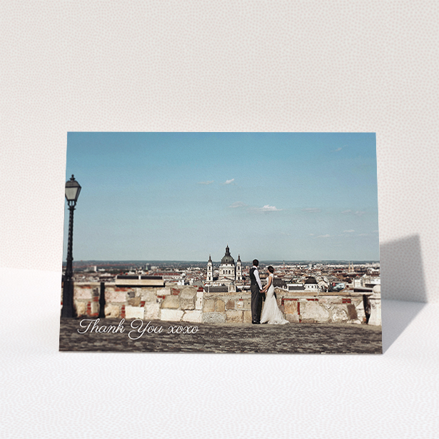 A wedding thank you card named "Italianno". It is an A5 card in a landscape orientation. It is a photographic wedding thank you card with room for 1 photo. "Italianno" is available as a folded card, with mainly white colouring.
