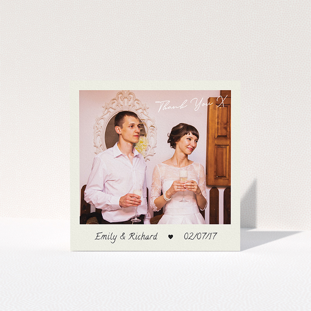 A wedding thank you card named "Keepsake". It is a square (148mm x 148mm) card in a square orientation. It is a photographic wedding thank you card with room for 1 photo. "Keepsake" is available as a folded card, with tones of cream and navy blue.