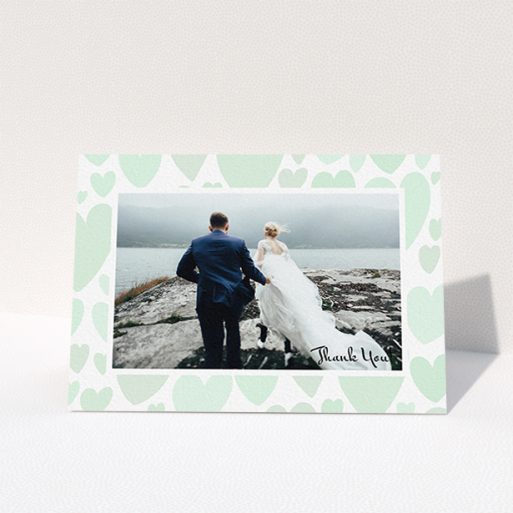 Wedding Thank You Card Design - "Mint Heart Frame" A wedding thank you card design named "Mint Heart Frame". It is an A6 card in a landscape orientation. It is a photographic wedding thank you card with room for 1 photo. "Mint Heart Frame" is available as a folded card, with tones of green and white.