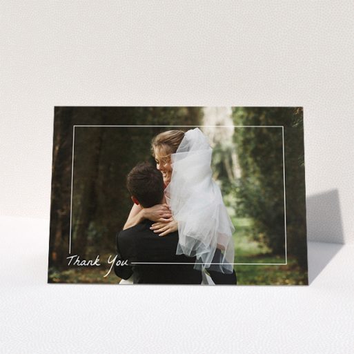 Wedding Thank You Card Design - "On Photo Border" A wedding thank you card called "On Photo Border". It is an A5 card in a landscape orientation. It is a photographic wedding thank you card with room for 1 photo. "On Photo Border" is available as a folded card, with mainly white colouring.