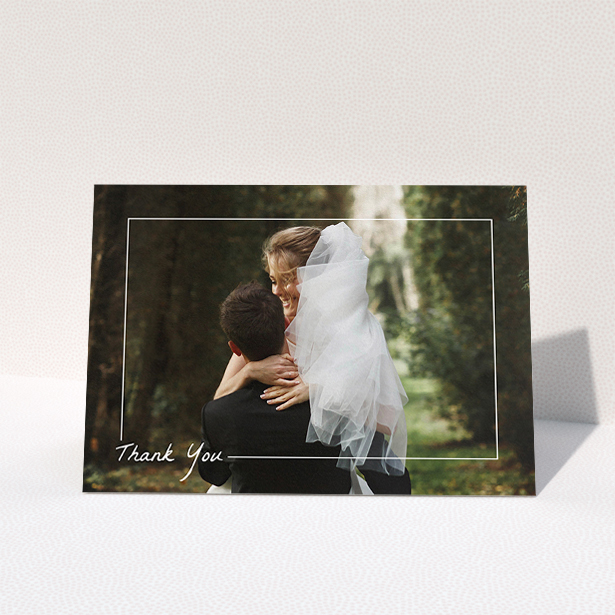A wedding thank you card called "On Photo Border". It is an A5 card in a landscape orientation. It is a photographic wedding thank you card with room for 1 photo. "On Photo Border" is available as a folded card, with mainly white colouring.