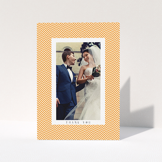 A wedding thank you card design called "Orange Houndstooth". It is an A6 card in a portrait orientation. It is a photographic wedding thank you card with room for 1 photo. "Orange Houndstooth" is available as a folded card, with tones of orange and white.