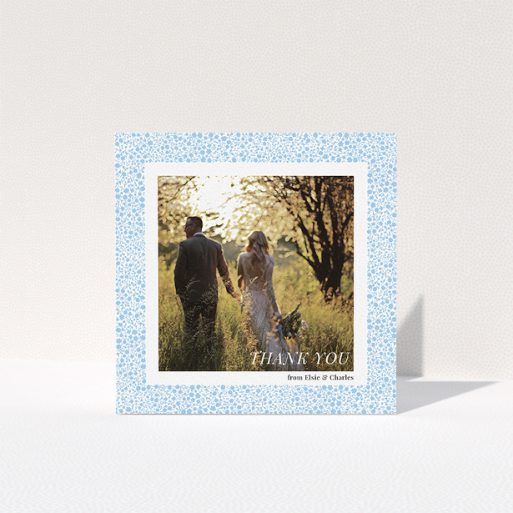 Wedding Thank You Card Design - "Surrounded by flowers" A wedding thank you card design called "Surrounded by flowers". It is a square (148mm x 148mm) card in a square orientation. It is a photographic wedding thank you card with room for 1 photo. "Surrounded by flowers" is available as a folded card, with tones of blue and white.