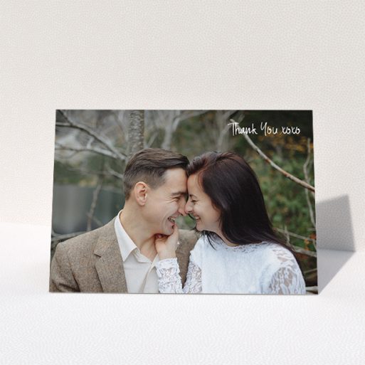 Wedding Thank You Card Design - "Thank You XOXO" A wedding thank you card template titled "Thank You XOXO". It is an A5 card in a landscape orientation. It is a photographic wedding thank you card with room for 1 photo. "Thank You XOXO" is available as a folded card, with mainly white colouring.