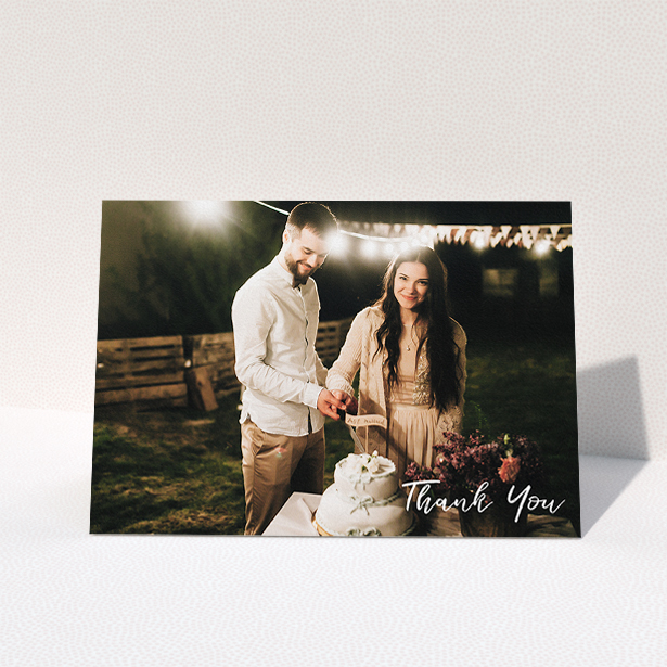 A wedding thank you card named "Thanks From The Corner". It is an A5 card in a landscape orientation. It is a photographic wedding thank you card with room for 1 photo. "Thanks From The Corner" is available as a folded card, with mainly white colouring.