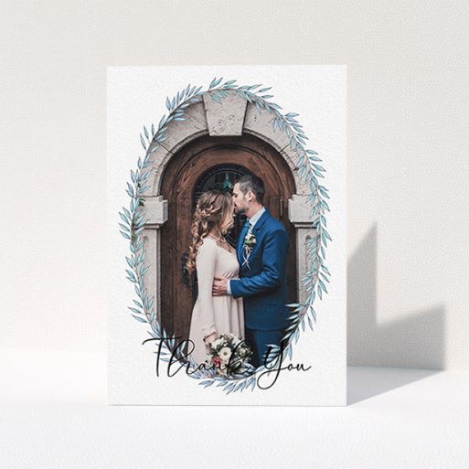 Wedding Thank You Card Design - "Tussled Wreath Frame" A wedding thank you card design named "Tussled Wreath Frame". It is an A6 card in a portrait orientation. It is a photographic wedding thank you card with room for 1 photo. "Tussled Wreath Frame" is available as a folded card, with mainly blue colouring.
