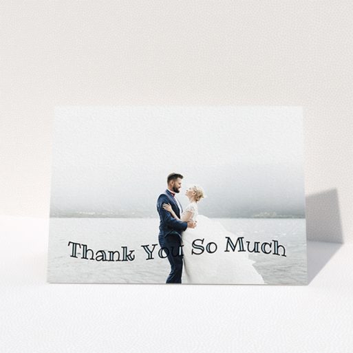 Wedding Thank You Card Design - "Wave of Thanks" A wedding thank you card design named "Wave of Thanks". It is an A6 card in a landscape orientation. It is a photographic wedding thank you card with room for 1 photo. "Wave of Thanks" is available as a folded card, with mainly blue colouring.
