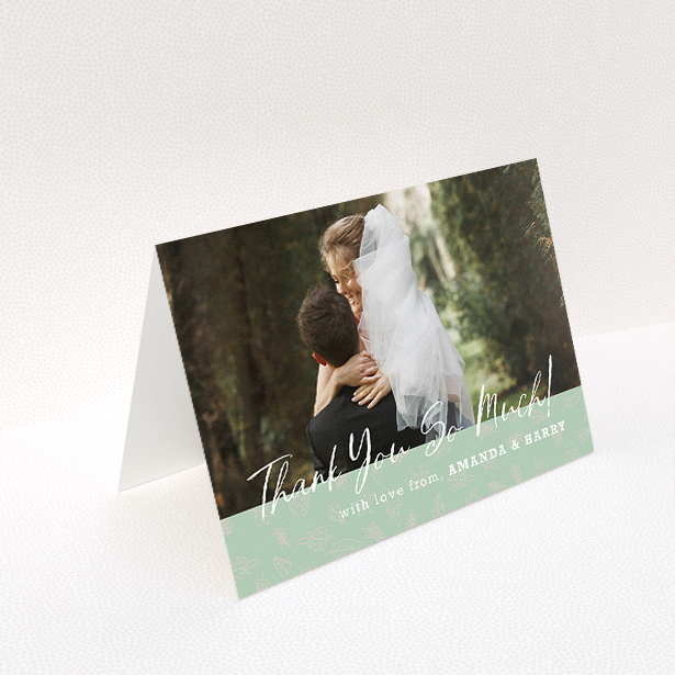 A wedding thank you card design called "Woodland Footer". It is an A5 card in a landscape orientation. It is a photographic wedding thank you card with room for 1 photo. "Woodland Footer" is available as a folded card, with tones of green and white.