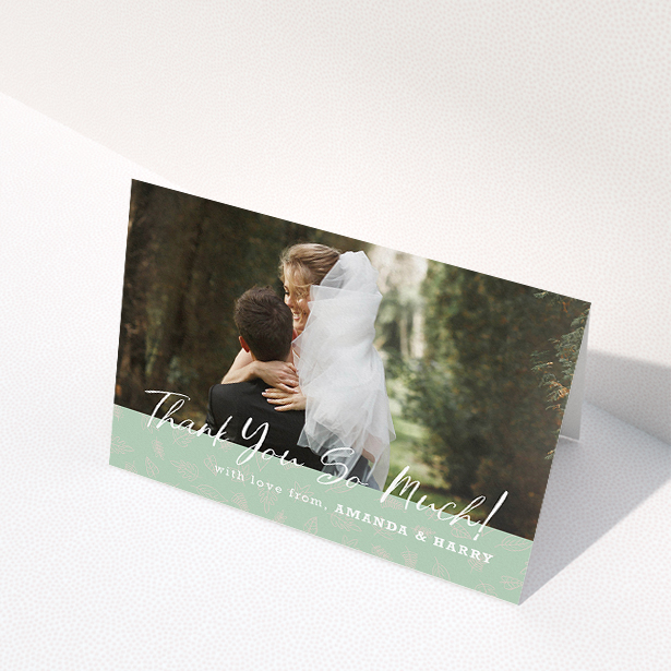 A wedding thank you card design called "Woodland Footer". It is an A5 card in a landscape orientation. It is a photographic wedding thank you card with room for 1 photo. "Woodland Footer" is available as a folded card, with tones of green and white.