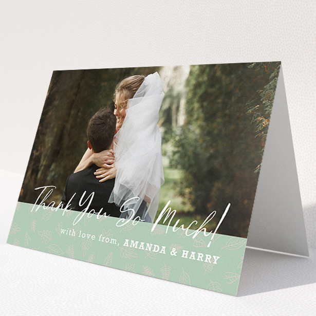 A wedding thank you card design called "Woodland Footer". It is an A5 card in a landscape orientation. It is a photographic wedding thank you card with room for 1 photo. "Woodland Footer" is available as a folded card, with tones of green and white.