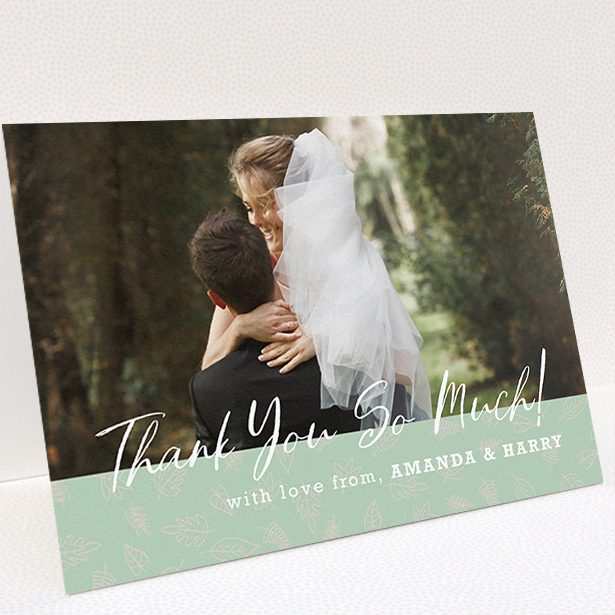 A wedding thank you card design called "Woodland Footer". It is an A5 card in a landscape orientation. It is a photographic wedding thank you card with room for 1 photo. "Woodland Footer" is available as a folded card, with tones of green and white.