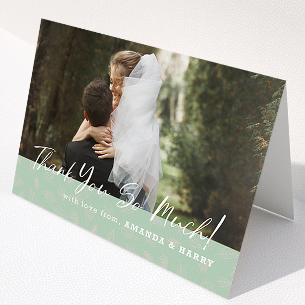 A wedding thank you card design called "Woodland Footer". It is an A5 card in a landscape orientation. It is a photographic wedding thank you card with room for 1 photo. "Woodland Footer" is available as a folded card, with tones of green and white.